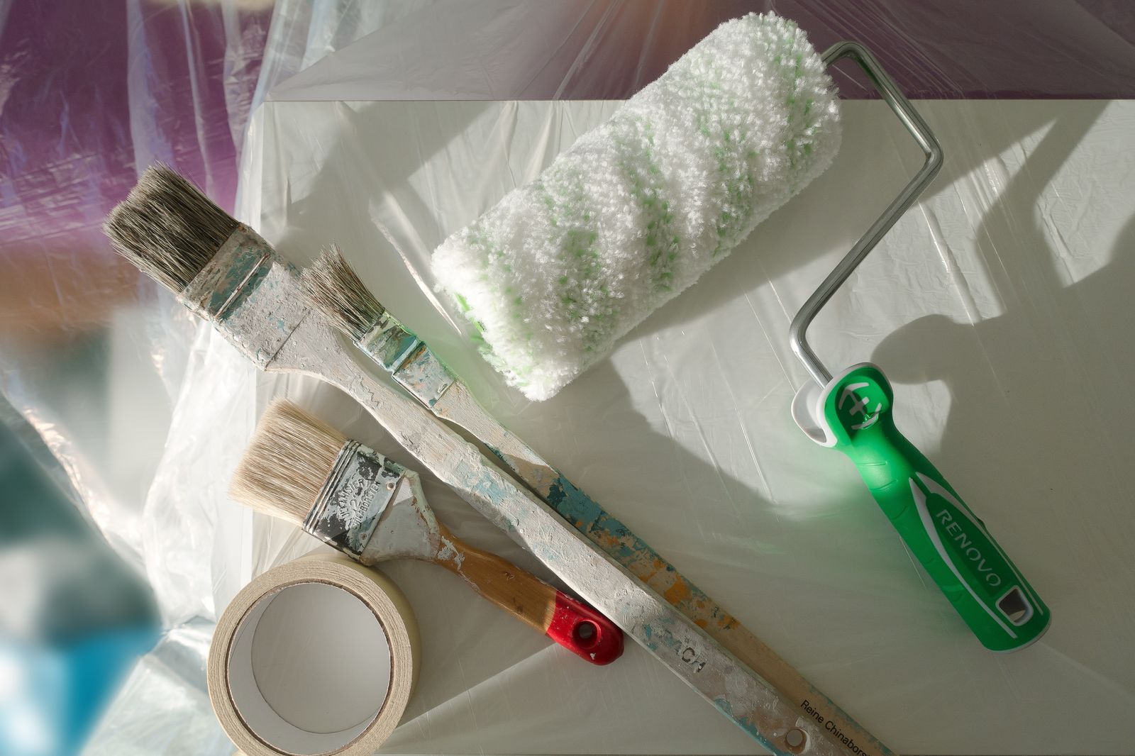 Painting tools laid out on protective sheeting before interior work begins