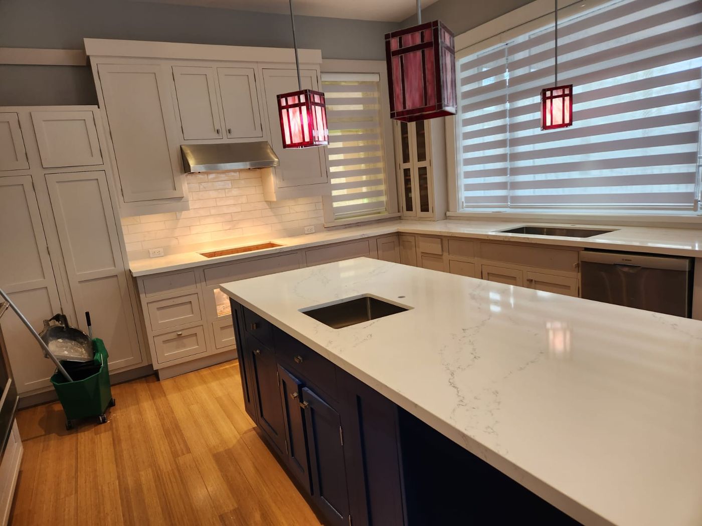 Finished kitchen with quartz counters, tiled backsplash and new cabinetry
