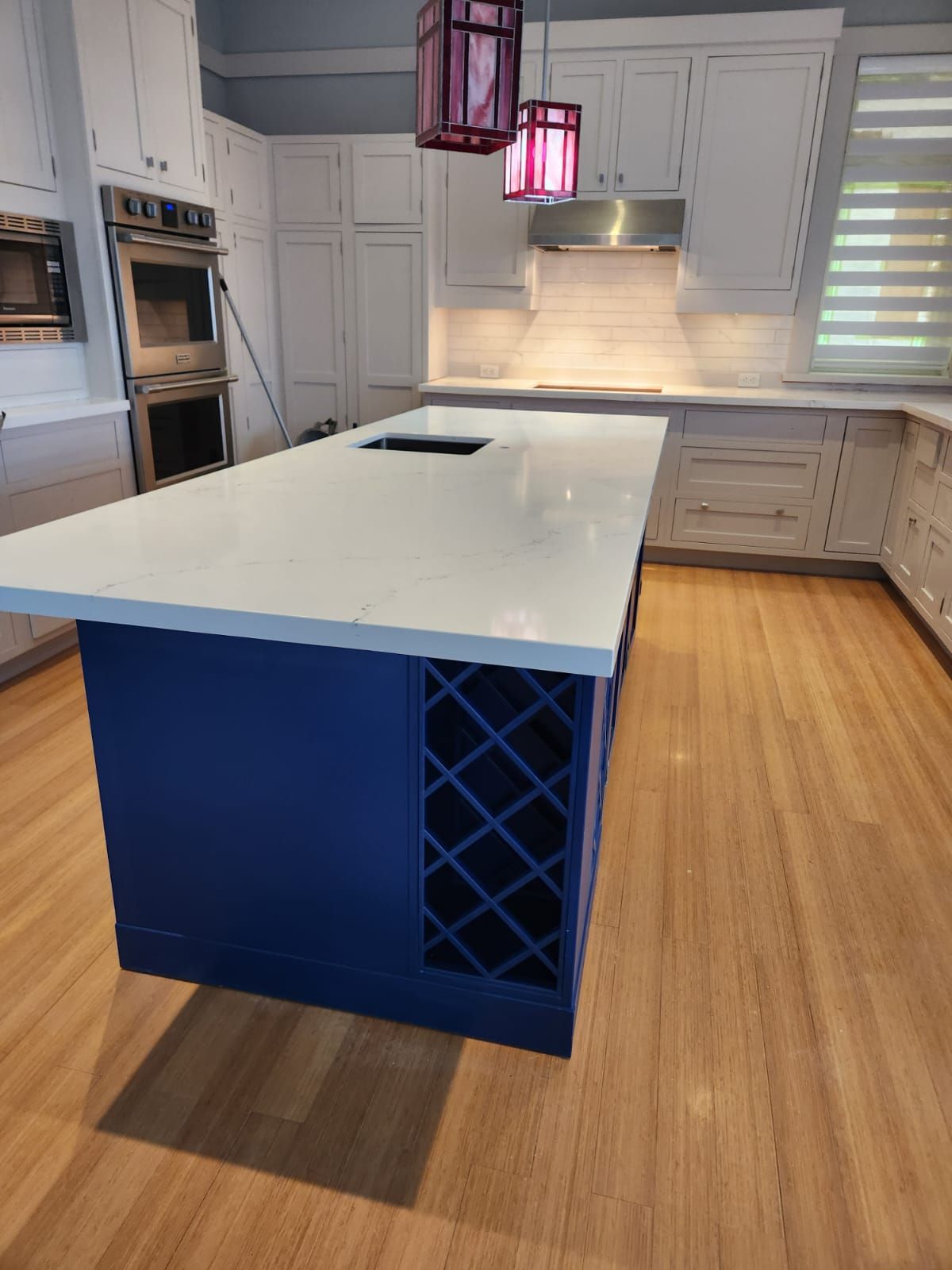 Kitchen island and cabinetry with new flooring in place