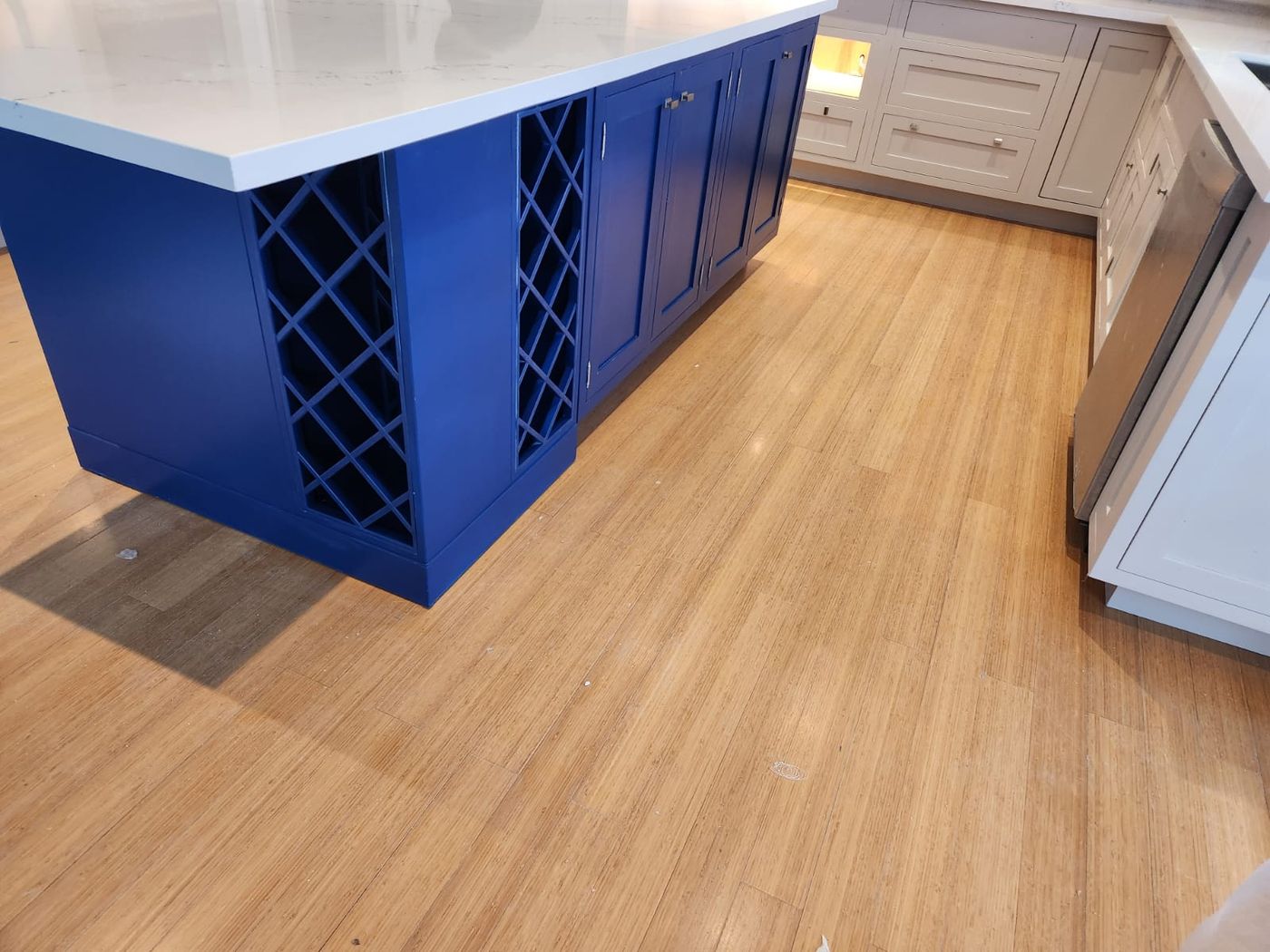 Kitchen island with wine storage and finished hardwood floor