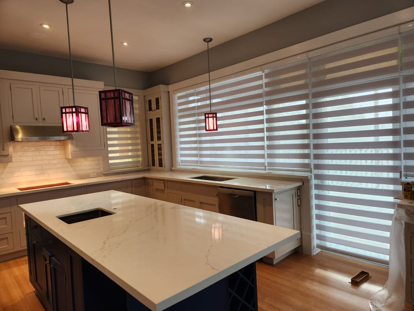 Kitchen with new cabinetry, counters and window treatments installed