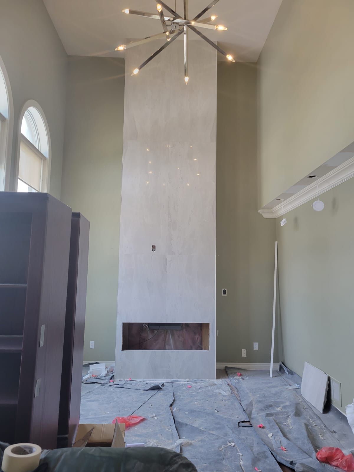 Full-height fireplace surround finished in large-format stone