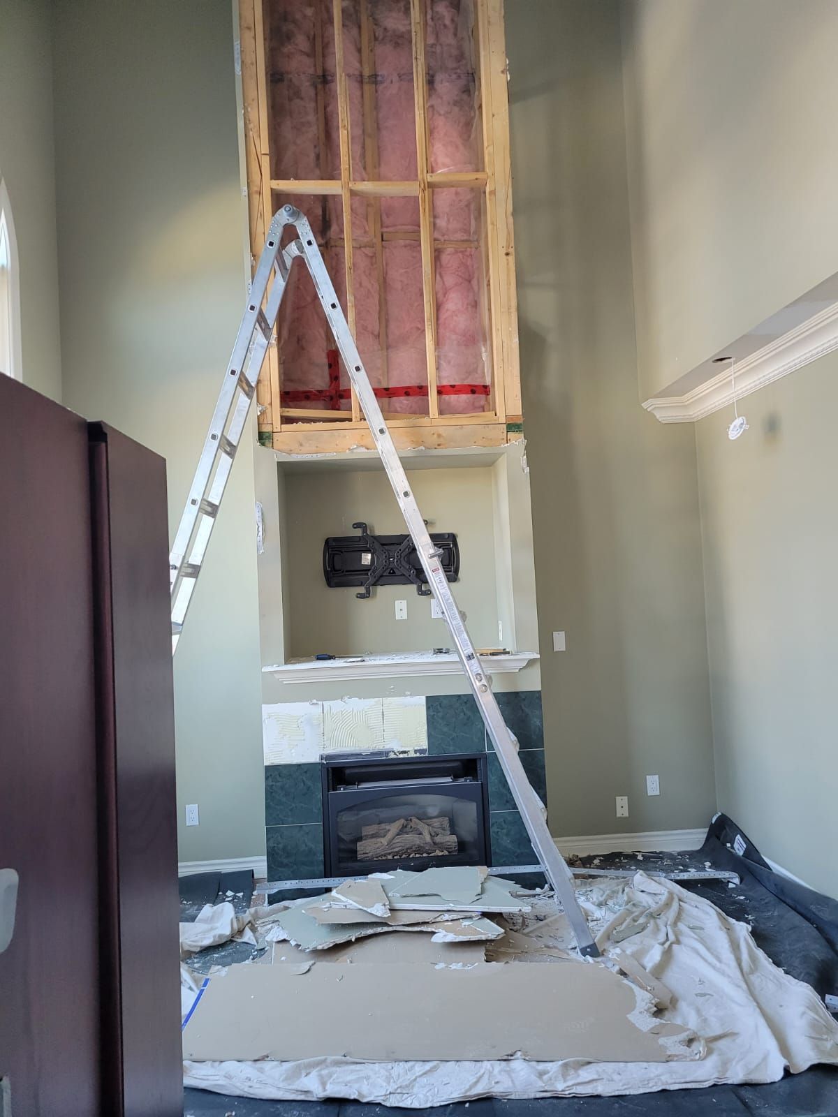 Fireplace wall opened up and framed for a new stone surround