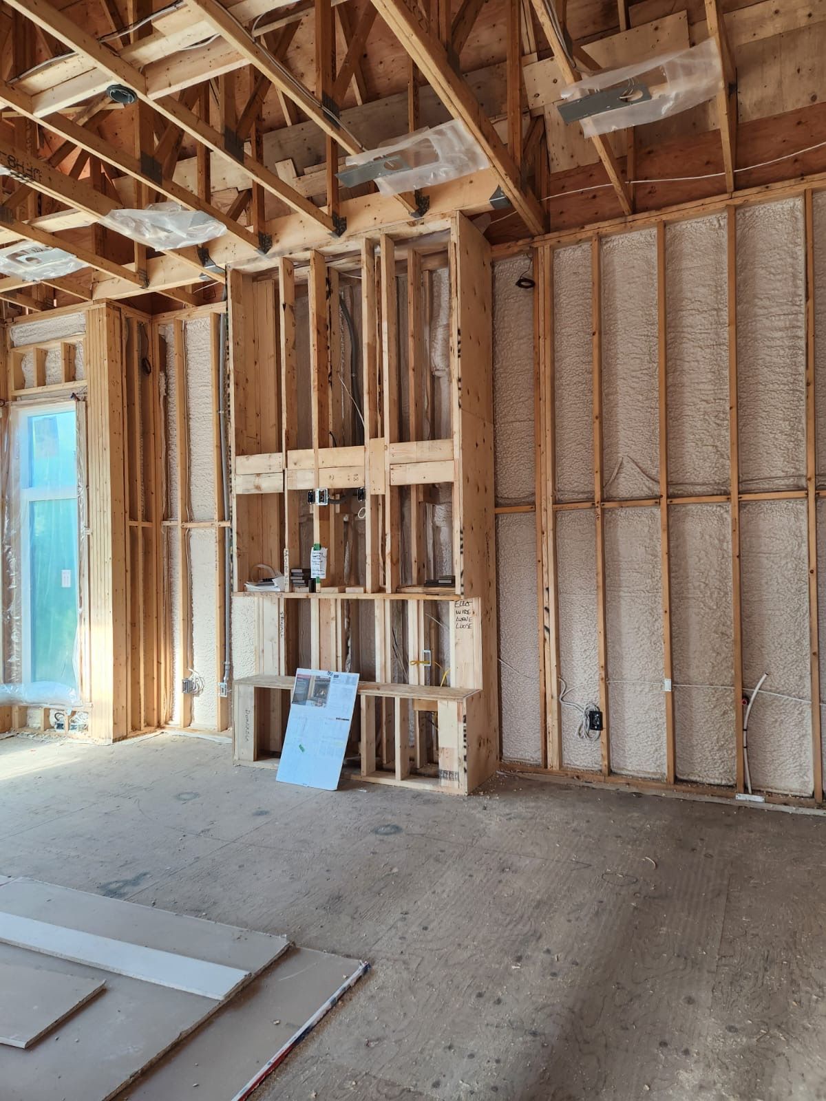 Framed wall with insulation and rough electrical runs