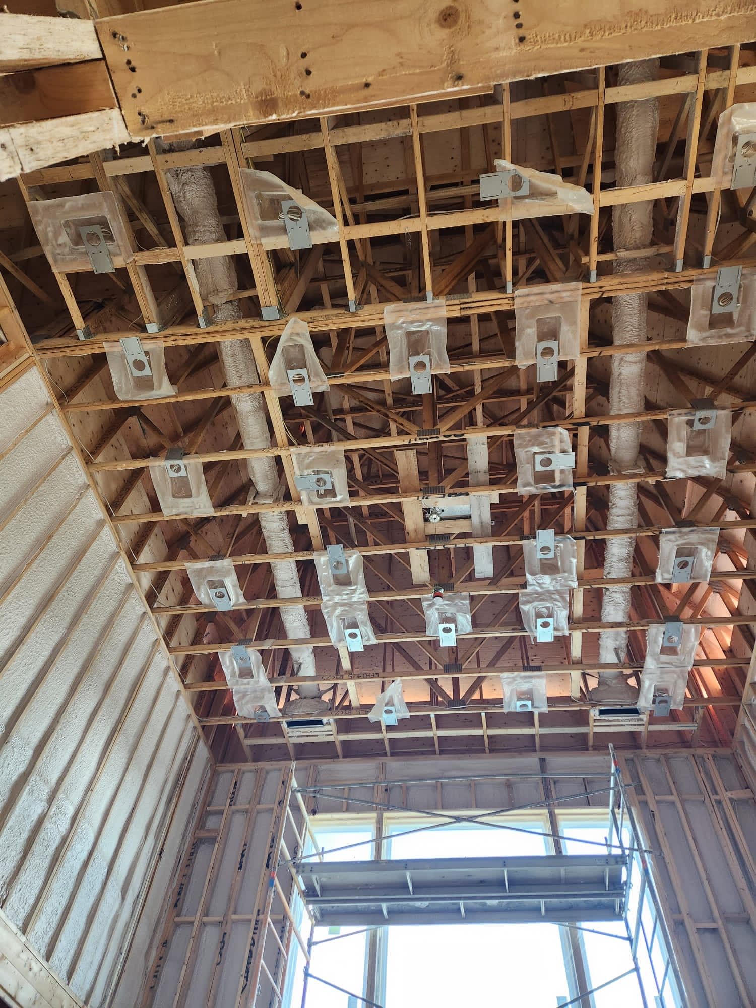 Ceiling framing with ducting and light boxes set before drywall