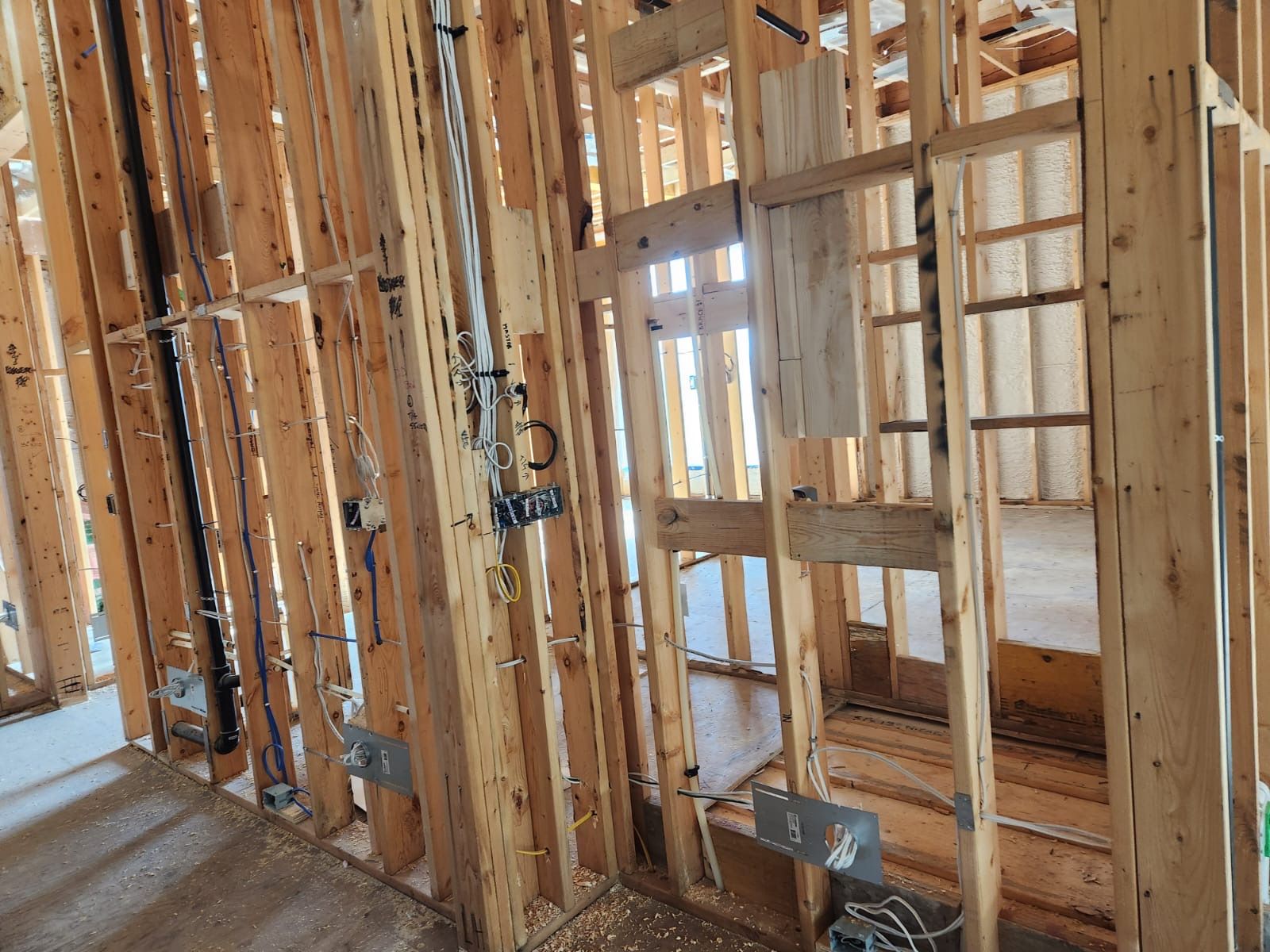Framed interior walls with rough electrical boxes and conduit