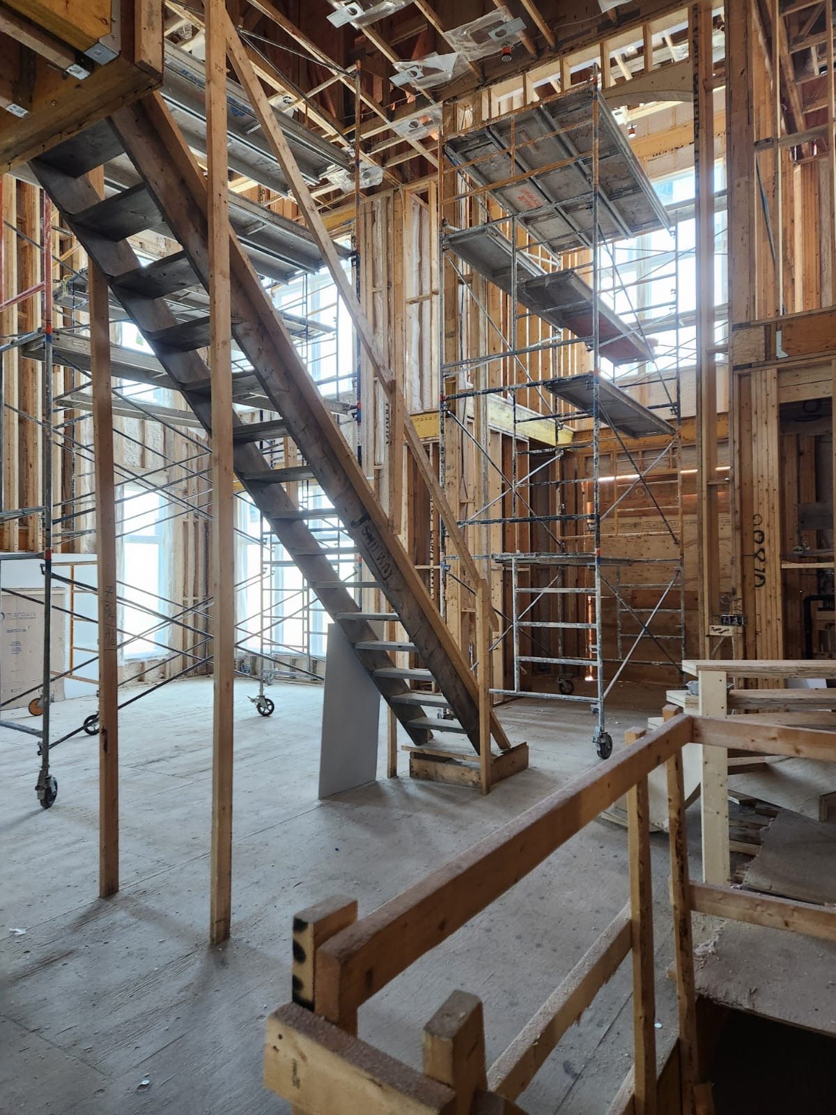 Stair framing and scaffolding inside a home under construction
