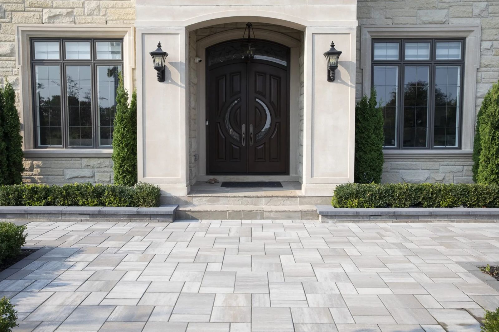 Front entrance with stone steps and a paver walkway